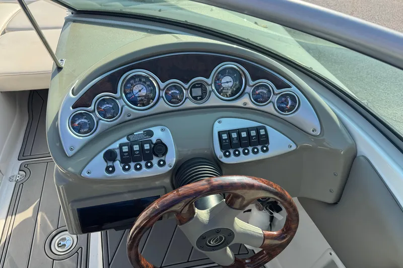 Slide: The Image of Dashboard of a 2007 Crownline 240 EX boat with gauges and controls. - 32