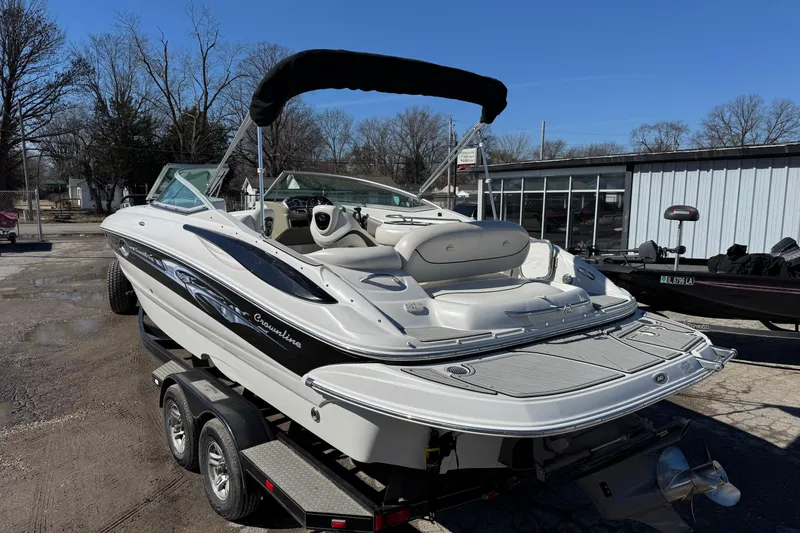Slide: The Image of 2007 Crownline 240 EX boat on trailer, featuring sleek design and spacious seating. - 4