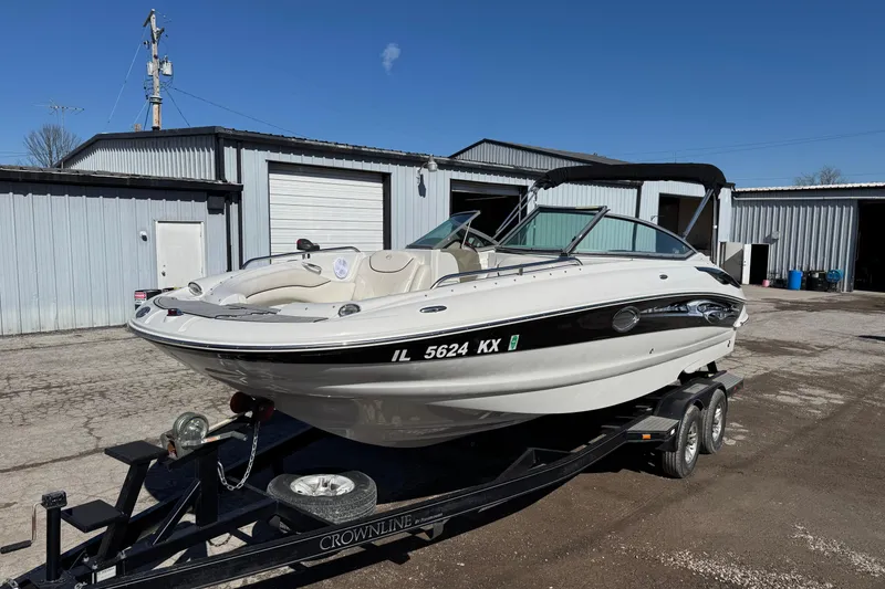 Slide: The Image of 2007 Crownline 240 EX boat on trailer, parked outside industrial building. - 5
