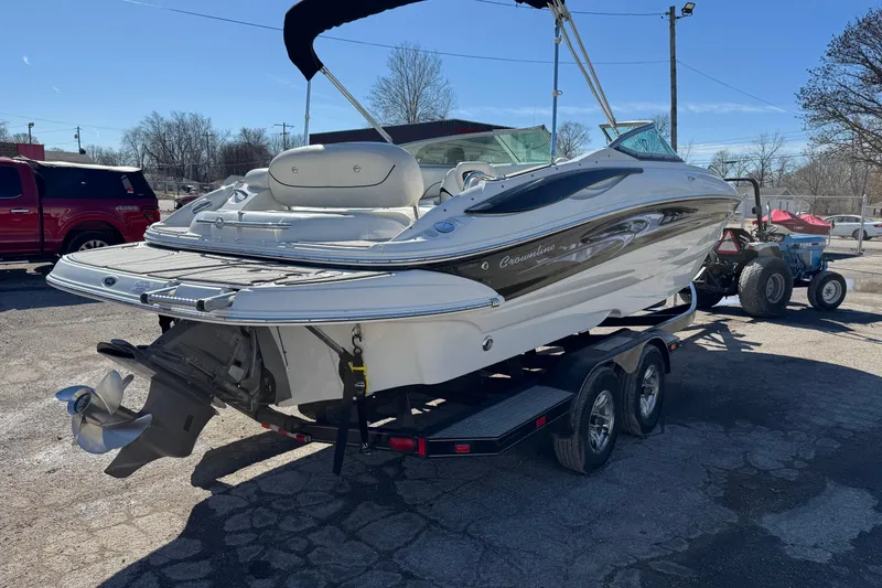 Slide: The Image of 2007 Crownline 240 EX boat on trailer, parked outdoors under clear sky. - 9