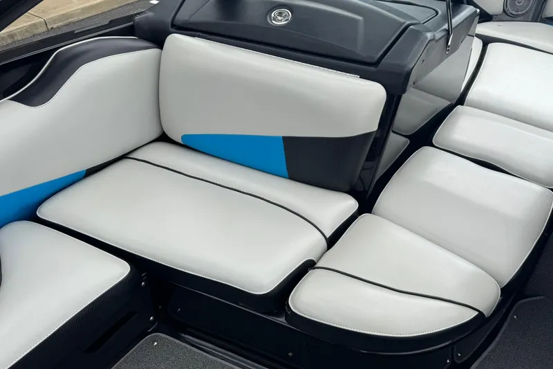 Slide: The Image of 2011 Axis A20 boat interior with white and blue cushioned seating. - 10