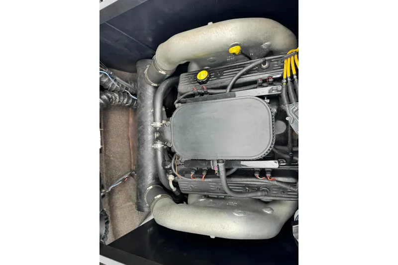 Slide: The Image of Engine of a 2011 Axis A20 boat, showcasing intricate components and hoses. - 12