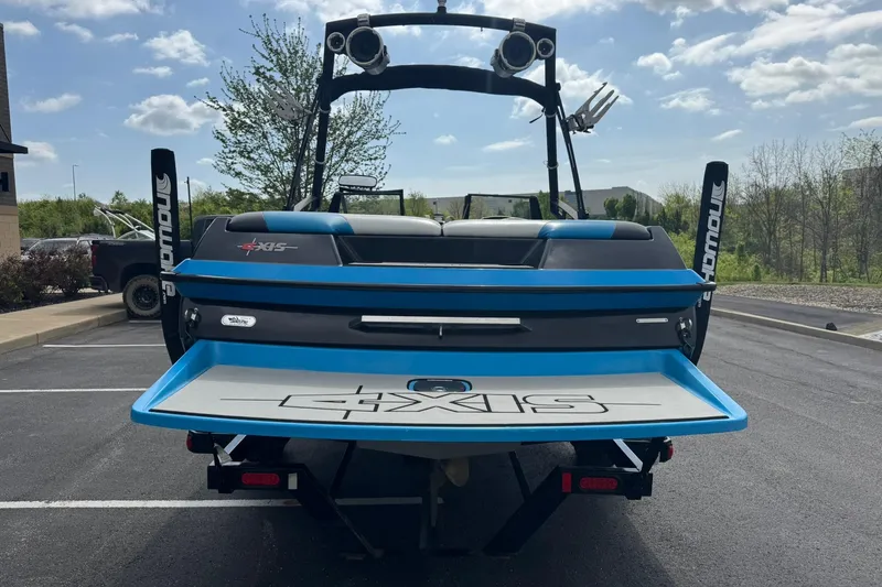 Slide: The Image of 2011 Axis A20 boat rear view with blue accents in parking lot. - 4