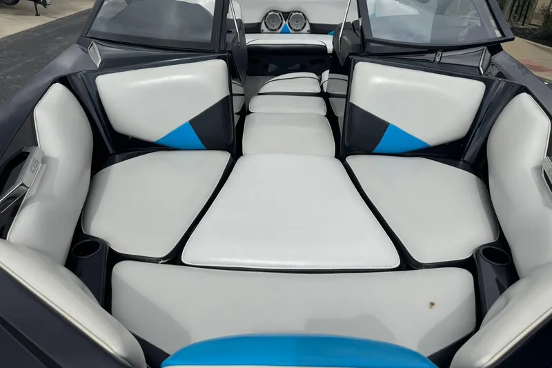 Slide: The Image of 2011 Axis A20 boat interior with white and blue cushioned seating. - 7