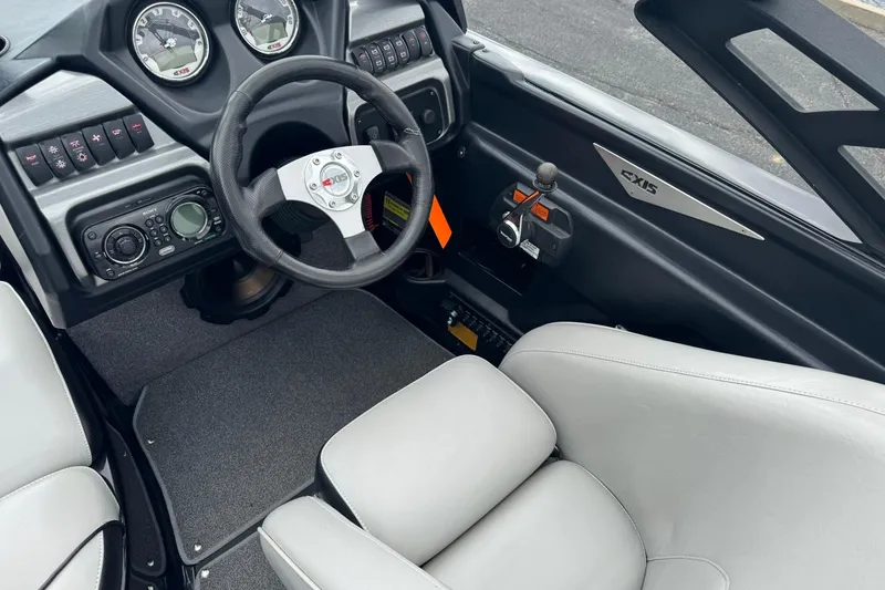 Slide: The Image of Interior of a 2011 Axis A20 boat featuring steering wheel and control panel. - 9