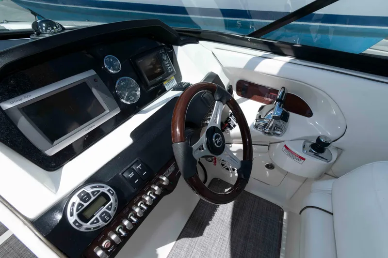 Slide: The Image of 2009 Sea Ray 300 SLX boat dashboard with steering wheel, controls, and navigation displays. - 3