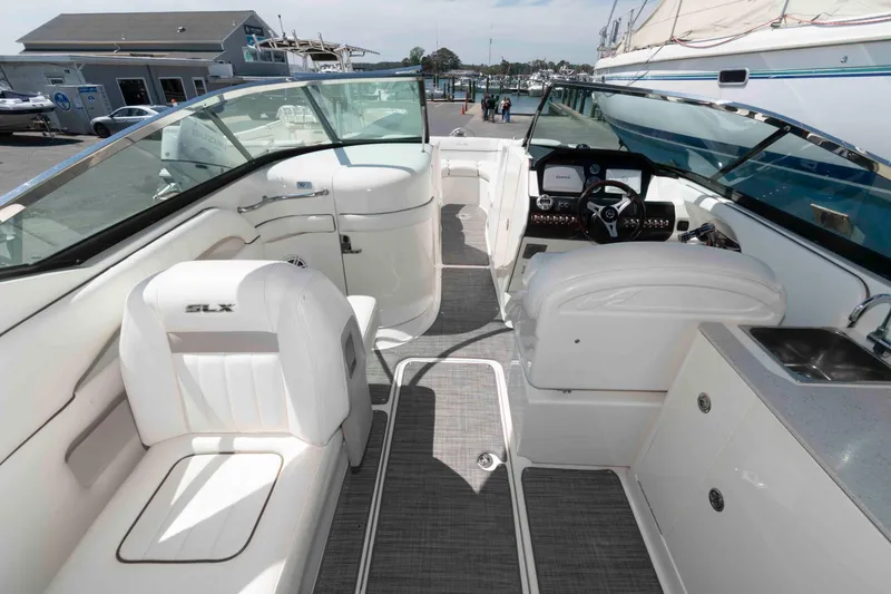 Slide: The Image of 2009 Sea Ray 300 SLX boat interior with white seating and modern dashboard. - 5