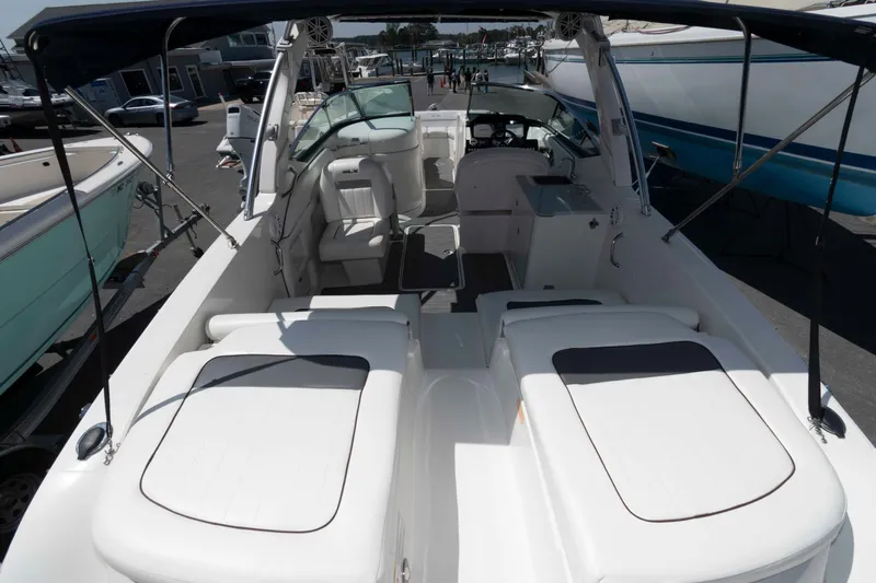 Slide: The Image of 2009 Sea Ray 300 SLX boat interior with seating and helm, docked at marina. - 6