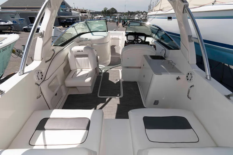 Slide: The Image of 2009 Sea Ray 300 SLX boat interior with seating and helm, docked at marina. - 7