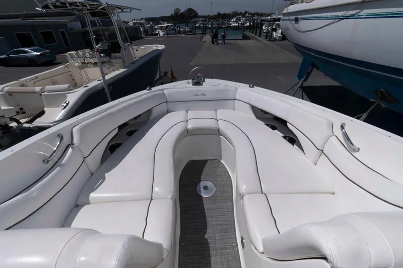Slide: The Image of 2009 Sea Ray 300 SLX boat with spacious white seating at a marina. - 8