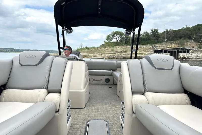Slide: The Image of 2018 Harris Grand Mariner 250 pontoon boat with luxurious seating on a scenic lake. - 16
