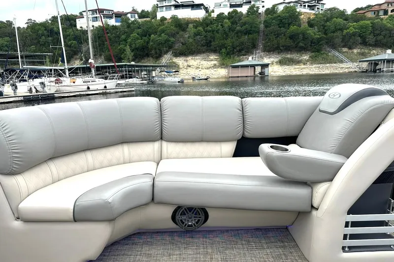 Slide: The Image of Luxurious seating on a 2018 Harris Grand Mariner 250 pontoon boat by a scenic marina. - 18