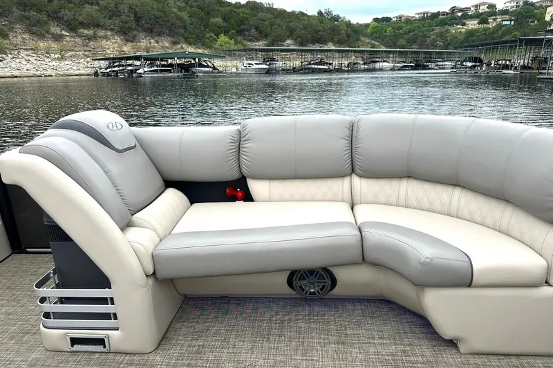 Slide: The Image of Luxurious seating on a 2018 Harris Grand Mariner 250 pontoon boat by a scenic lake. - 20