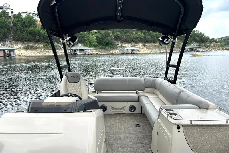 Slide: The Image of 2018 Harris Grand Mariner 250 pontoon boat interior on a scenic lake. - 24