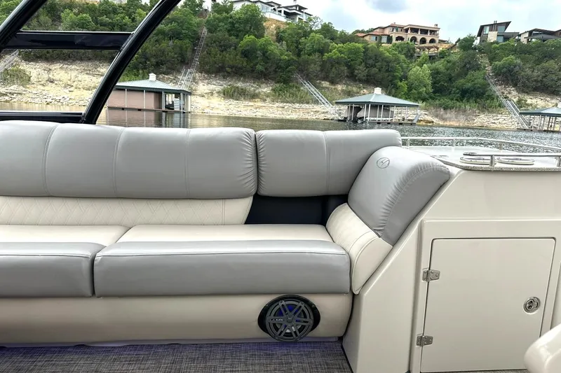 Slide: The Image of Luxurious seating on a 2018 Harris Grand Mariner 250 boat, with scenic waterfront view. - 28
