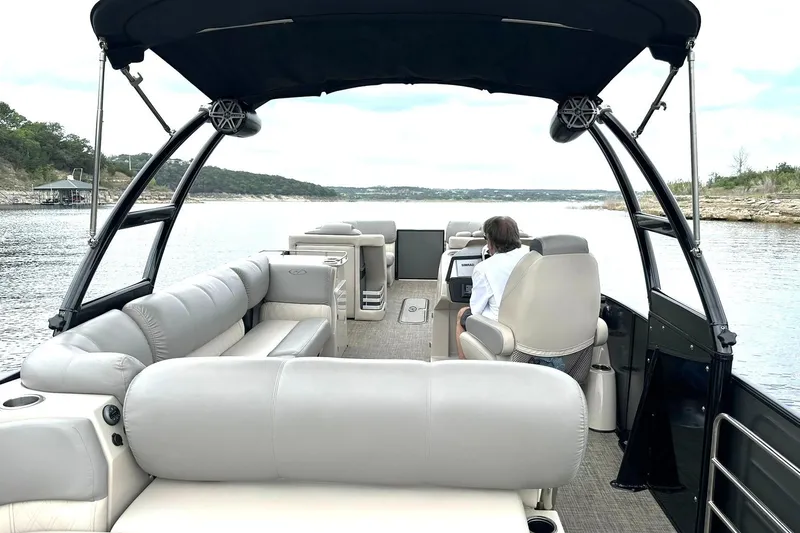Slide: The Image of 2018 Harris Grand Mariner 250 pontoon boat on a scenic lake. - 3