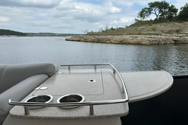 Slide: The Image of 2018 Harris Grand Mariner 250 boat with cup holders, scenic lake view. - 31