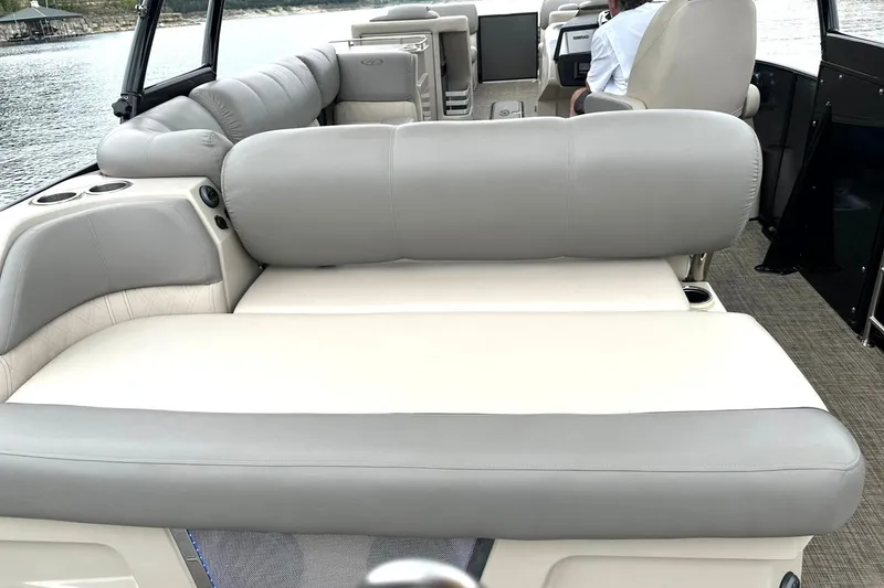 Slide: The Image of 2018 Harris Grand Mariner 250 pontoon boat with spacious seating and modern interior design. - 33