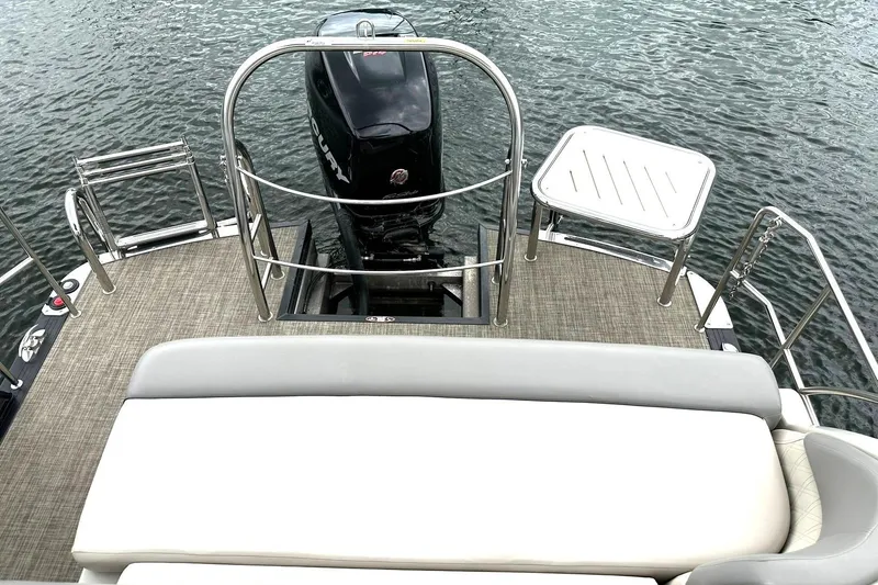 Slide: The Image of 2018 Harris Grand Mariner 250 boat deck with motor and seating, on water. - 35