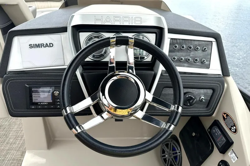 Slide: The Image of Steering console of 2018 Harris Grand Mariner 250 with Simrad display and JL Audio system. - 41