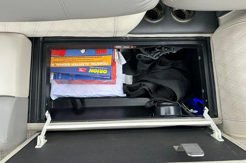 Slide: The Image of Storage compartment in a 2018 Harris Grand Mariner 250 boat with safety equipment. - 46