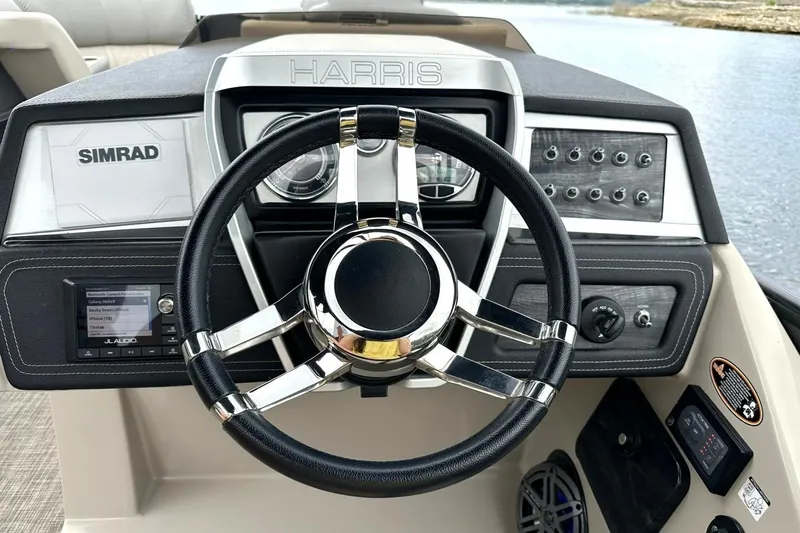 Slide: The Image of Steering console of 2018 Harris Grand Mariner 250 with Simrad electronics and audio controls. - 5