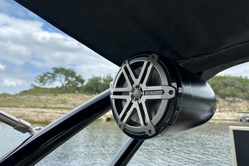 Slide: The Image of JL Audio speaker on 2018 Harris Grand Mariner 250 boat, scenic lake background. - 50