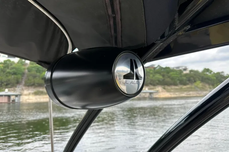 Slide: The Image of JL Audio speaker on 2018 Harris Grand Mariner 250 boat, near a scenic lake. - 51