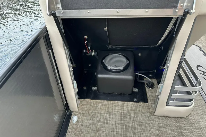 Slide: The Image of 2018 Harris Grand Mariner 250 boat interior showing storage compartment and speaker system. - 52