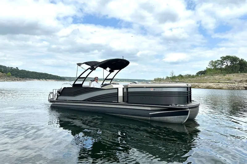 Slide: The Image of 2018 Harris Grand Mariner 250 pontoon boat on a scenic lake. - 6