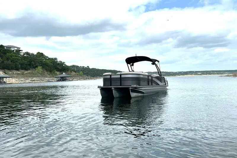 Slide: The Image of 2018 Harris Grand Mariner 250 pontoon boat on a serene lake. - 9