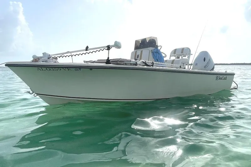 The Image of 1983 Sea Craft SF18 boat floating on clear turquoise water. - 1