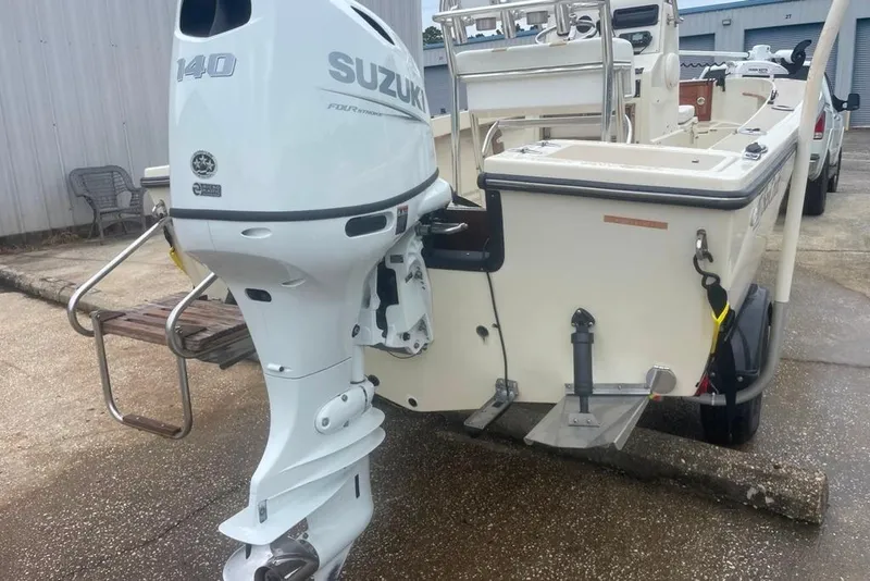 Slide: The Image of 1983 Sea Craft SF18 boat with Suzuki 140 outboard motor, parked on concrete. - 12
