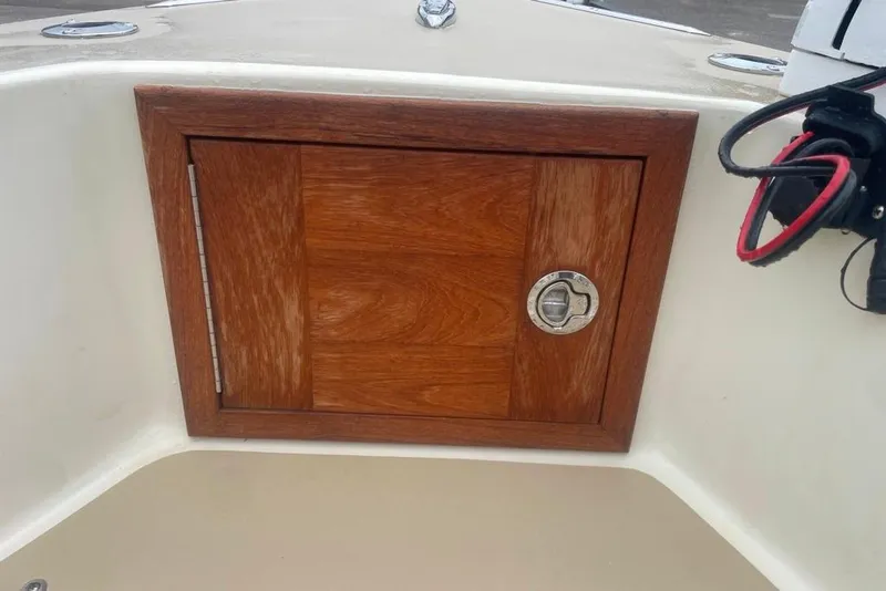 Slide: The Image of Wooden hatch on 1983 Sea Craft SF18 boat, featuring a metal latch. - 15
