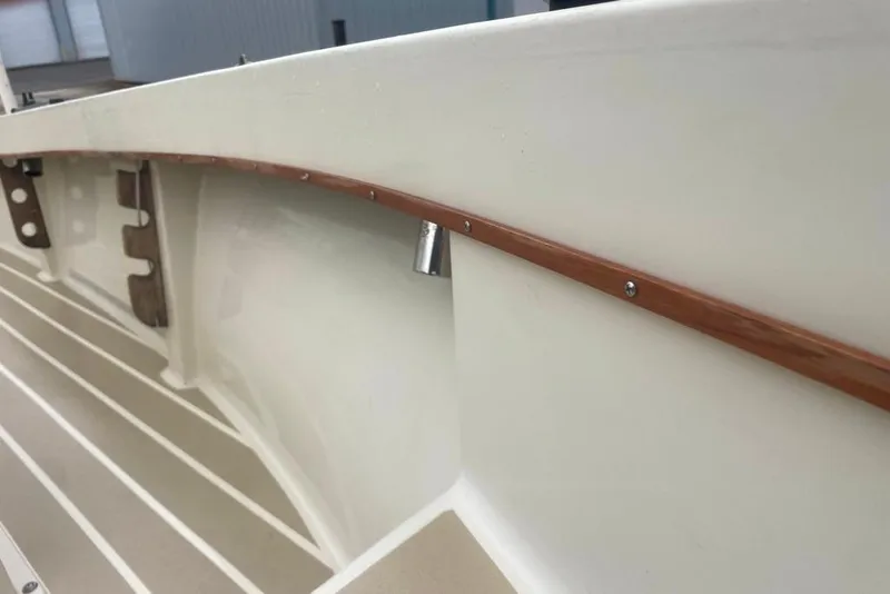 Slide: The Image of 1983 Sea Craft SF18 boat interior with wooden trim and clean white finish. - 16