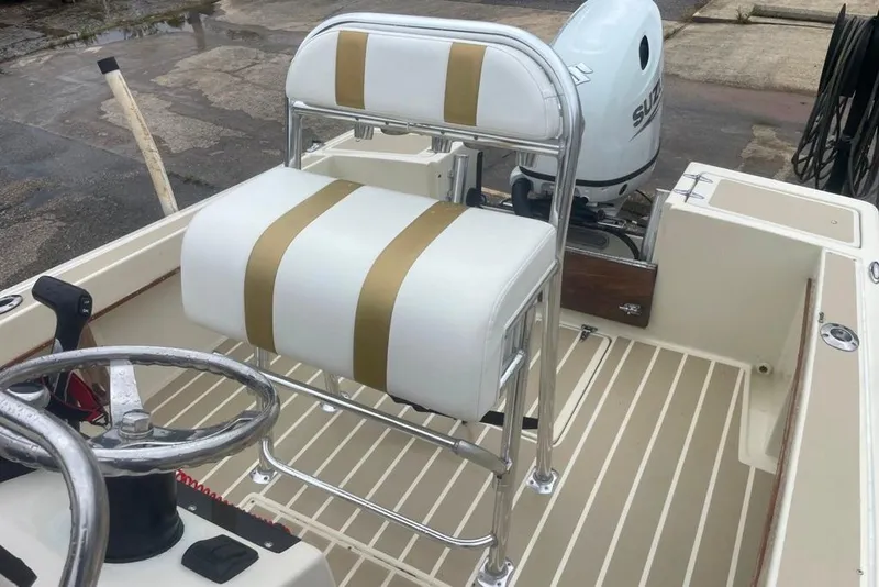 Slide: The Image of 1983 Sea Craft SF18 boat interior with white and gold seating, steering wheel, and Suzuki outboard motor. - 20