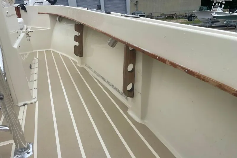 Slide: The Image of 1983 Sea Craft SF18 boat interior with striped flooring and wooden rail. - 27