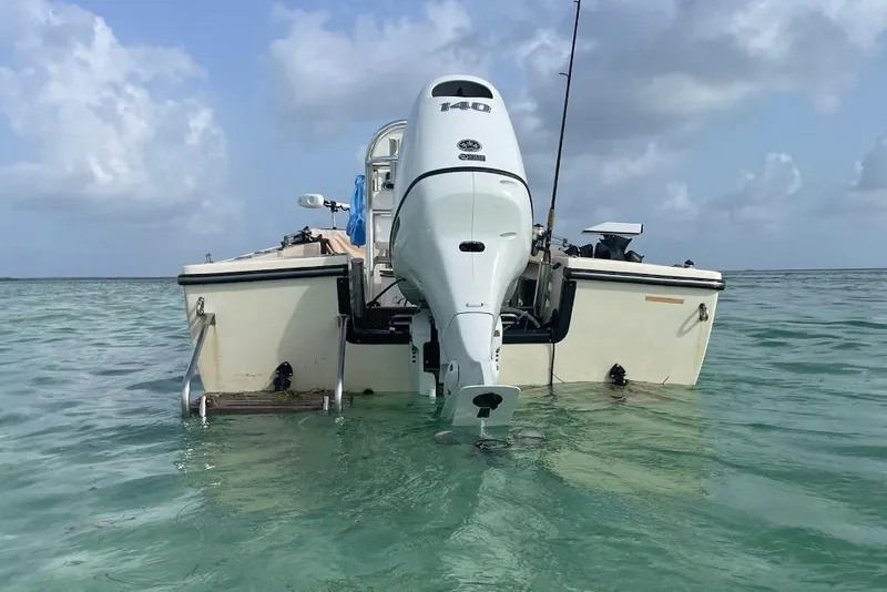 Slide: The Image of 1983 Sea Craft SF18 boat with Yamaha 140 outboard motor in clear turquoise water. - 3