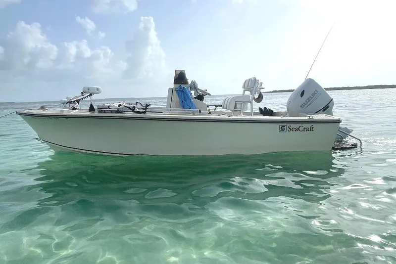 Slide: The Image of 1983 Sea Craft SF18 boat floating on clear turquoise water under a cloudy sky. - 4