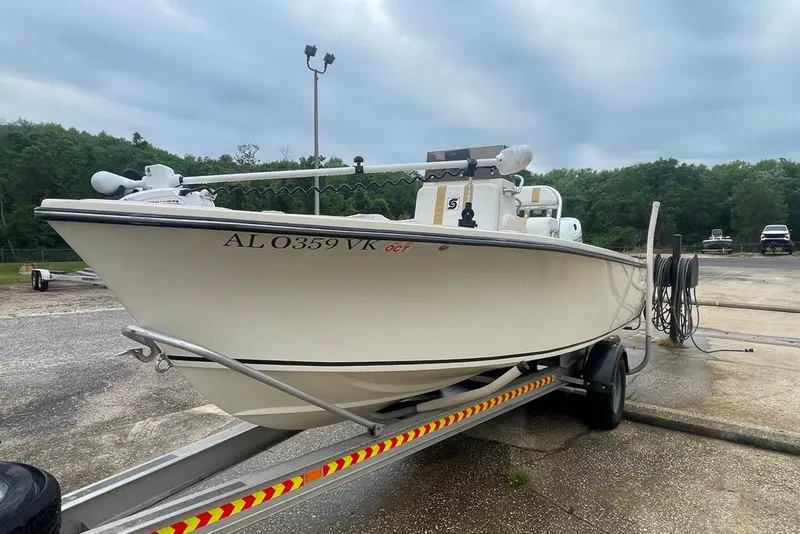 Slide: The Image of 1983 Sea Craft SF18 boat on trailer, parked outdoors under cloudy sky. - 6