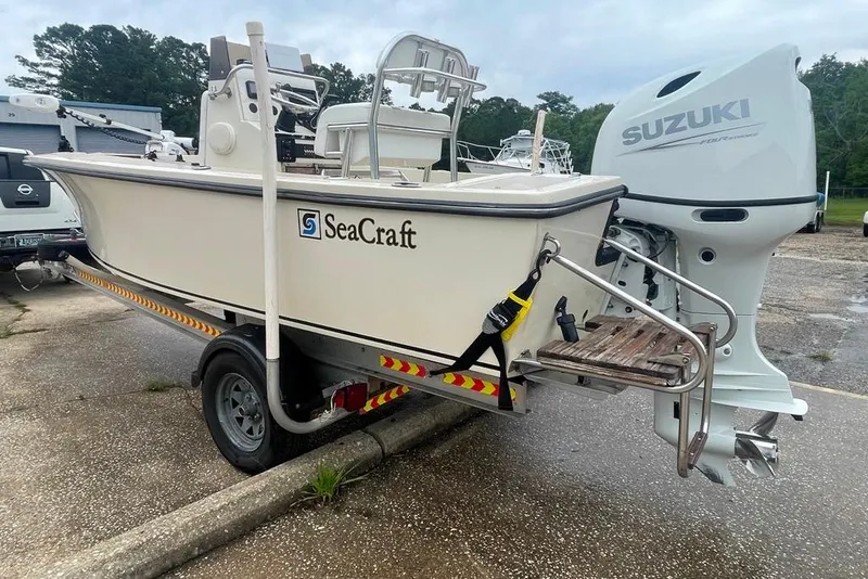 Slide: The Image of 1983 Sea Craft SF18 boat with Suzuki outboard motor on a trailer. - 8