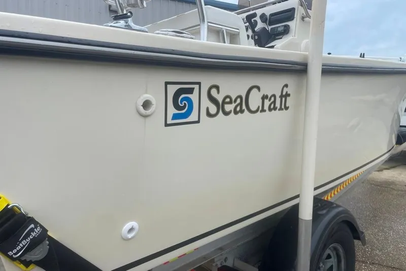 Slide: The Image of 1983 Sea Craft SF18 boat on trailer, showcasing logo and side view. - 9