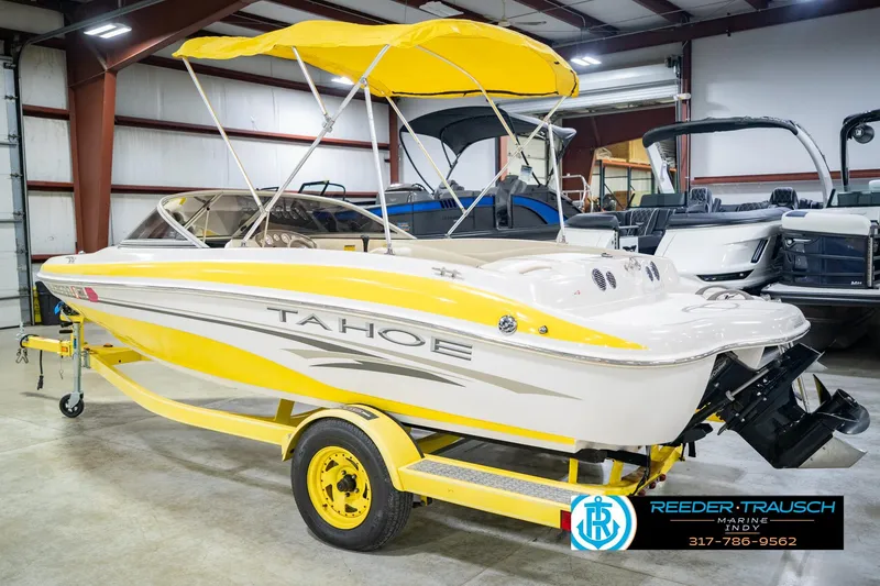 Slide: The Image of Yellow 2005 Tahoe Q4 boat with canopy on trailer in indoor showroom. - 10