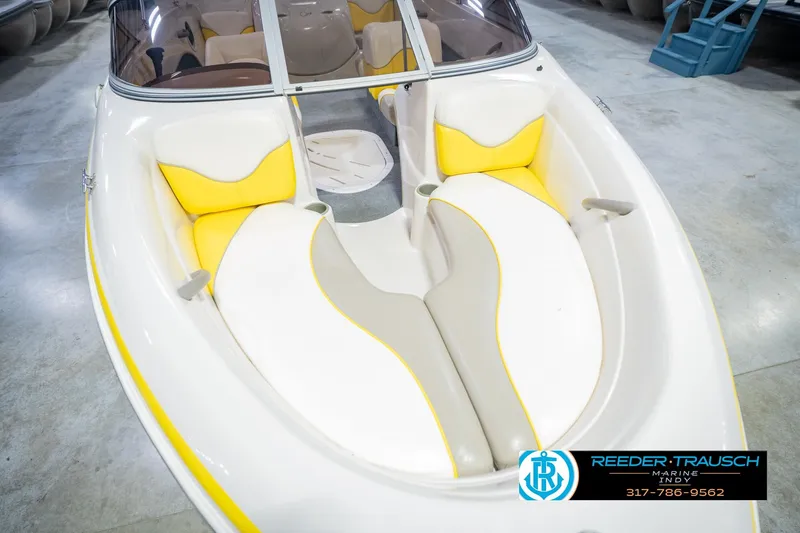 Slide: The Image of 2005 Tahoe Q4 boat interior with yellow and white seating, displayed at Reeder Trausch Marine. - 13