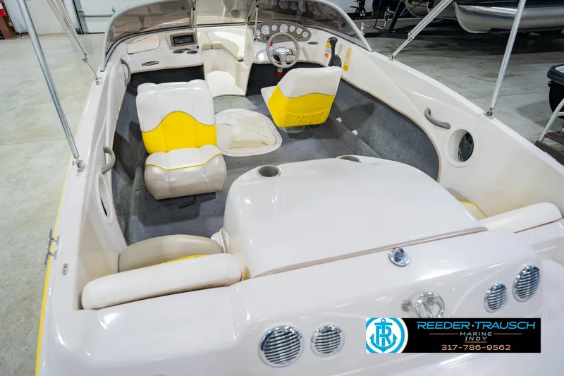 Slide: The Image of 2005 Tahoe Q4 boat interior with yellow and white seating, steering wheel, and dashboard. - 15