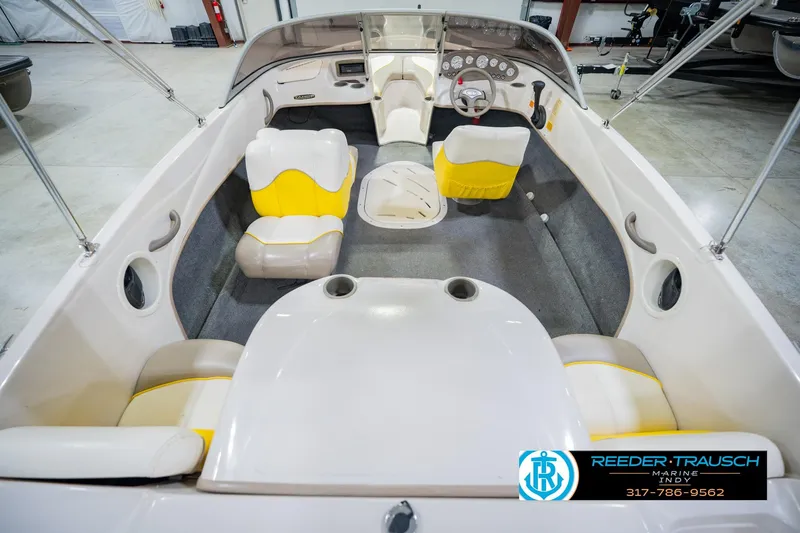 Slide: The Image of Interior of a 2005 Tahoe Q4 boat with yellow and white seating. - 16
