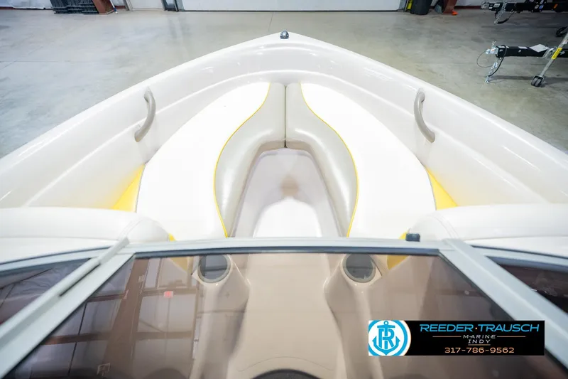 Slide: The Image of 2005 Tahoe Q4 boat interior with white and yellow seating, viewed from the bow. - 18