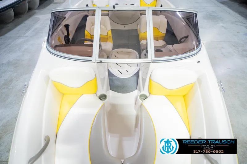 Slide: The Image of 2005 Tahoe Q4 boat interior with yellow and white seating, displayed at Reeder Trausch Marine. - 19