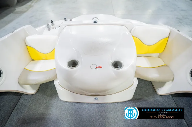 Slide: The Image of 2005 Tahoe Q4 boat interior with yellow and white seating, featuring cup holders. - 21