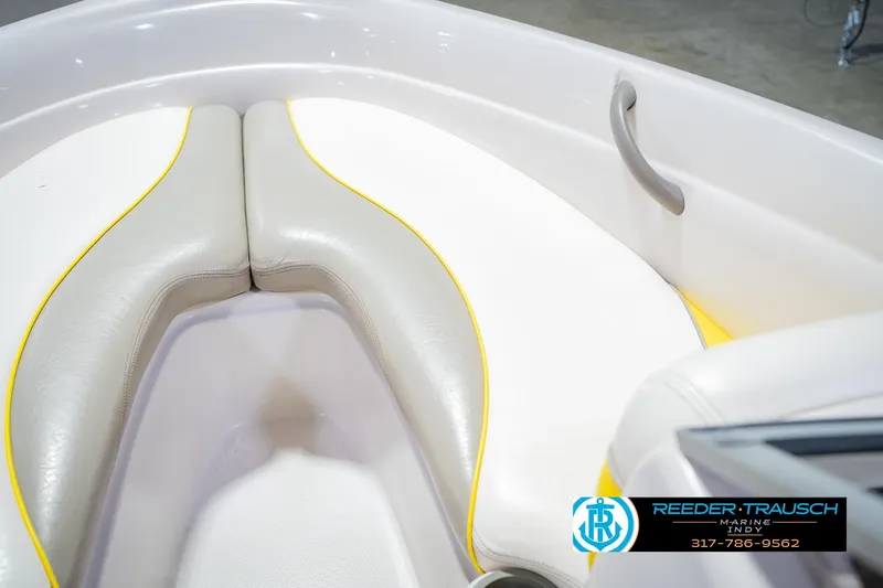 Slide: The Image of Interior seating of a 2005 Tahoe Q4 boat with white and yellow upholstery. - 22